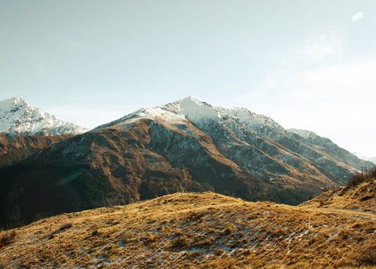 Golden Hills and Snowy Mountain Peaks