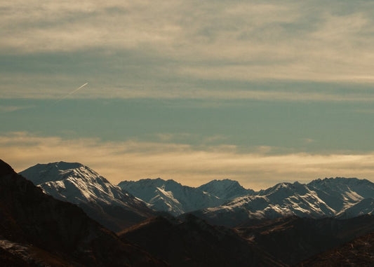 Distant Snowy Range Under Golden Clouds